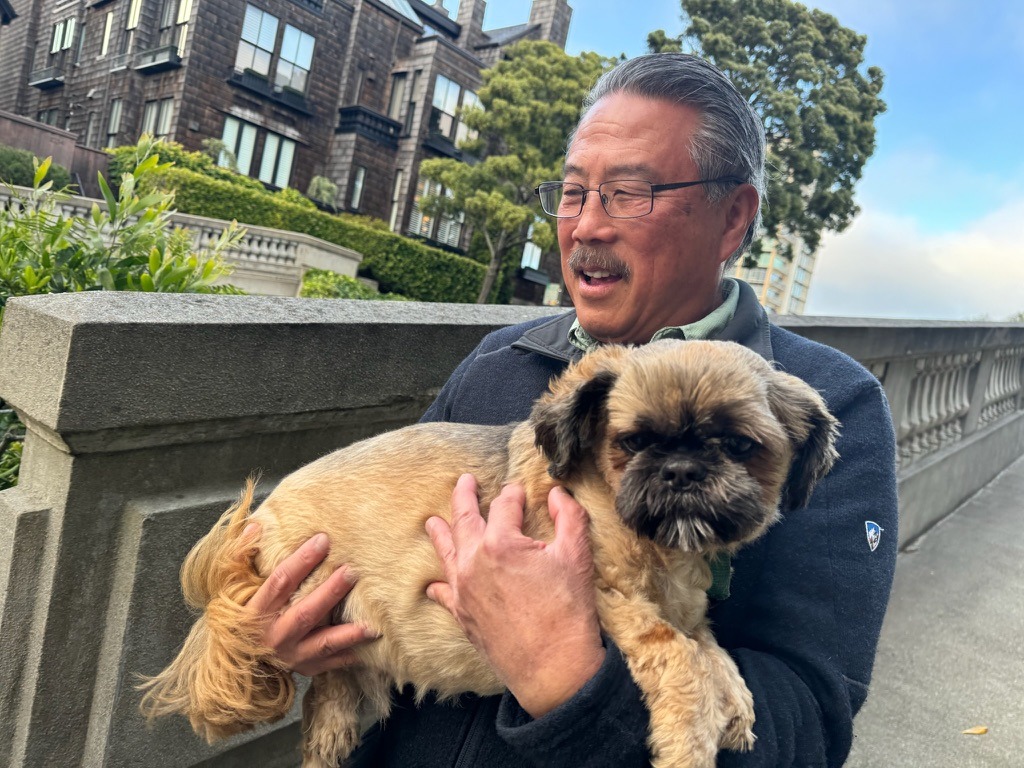 Mel holding a small dog