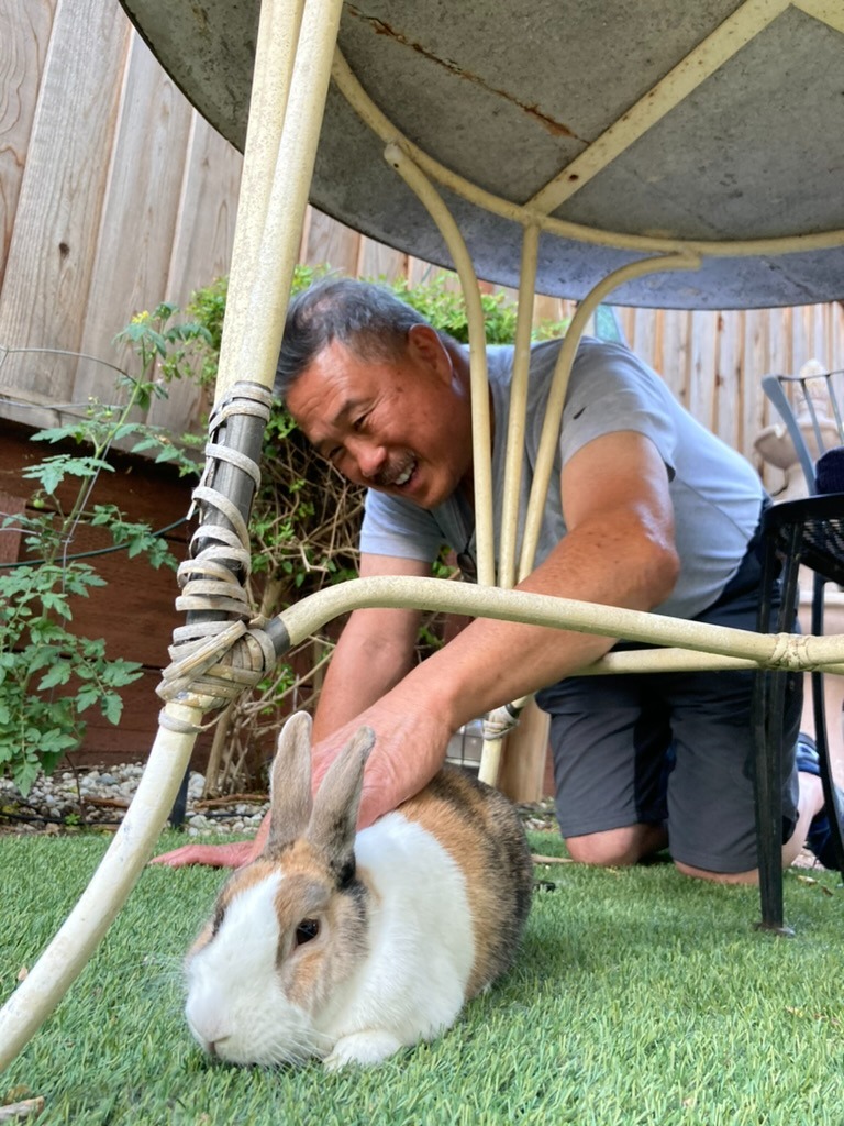 Mel with a rabbit in the backyard