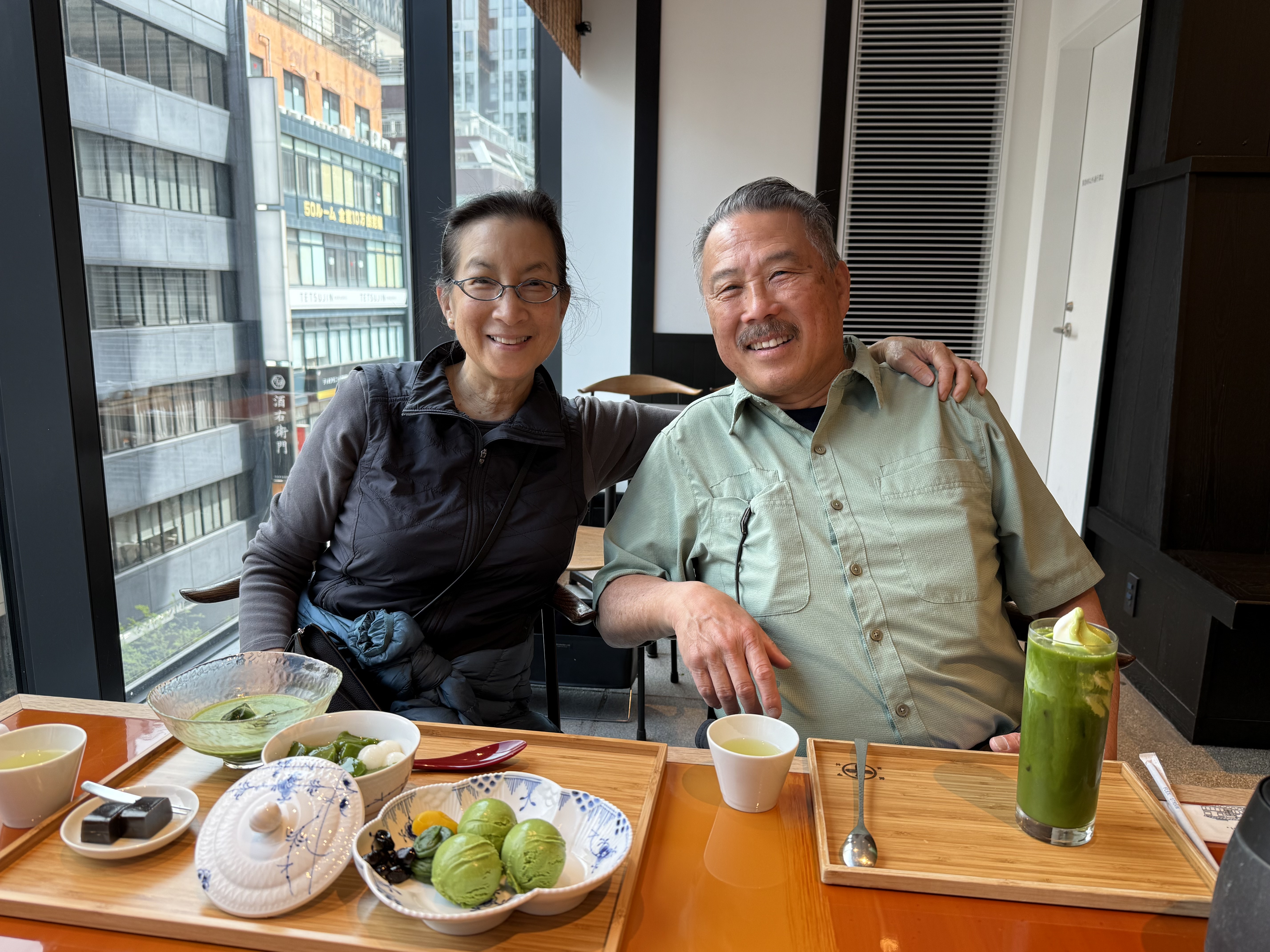 Joanne and Mel at lunch with matcha drinks, smiling at the camera
